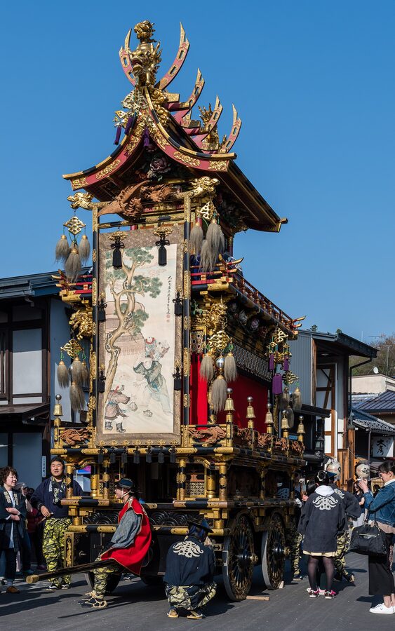 Spring yatai parading through Takayama old town with paper streamers