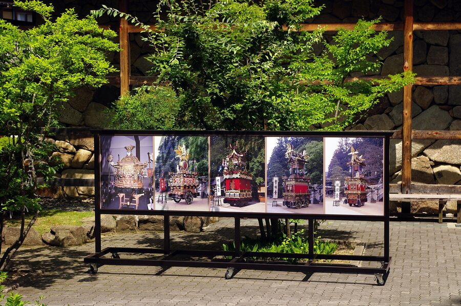 Multiple Takayama festival yatai lined up in front of shrine grounds