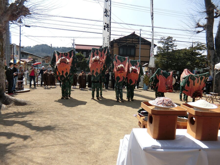 Shishimai lion dance two performers under red and gold lion at Takayama festival