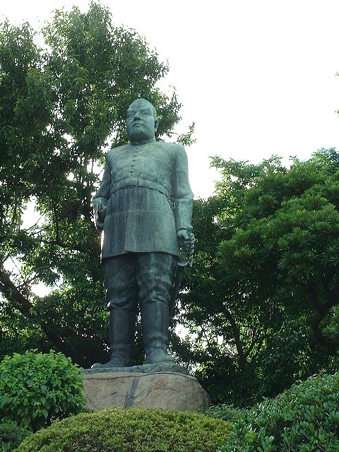 Bronze statue of Saigo Takamori in Western military uniform standing on a granite plinth in central Kagoshima
