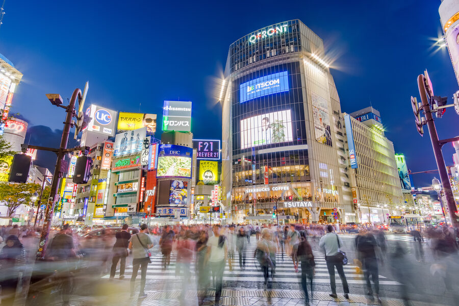 Long-exposure photograph of pedestrians at Shibuya Scramble Crossing taken from above Hachiko exit