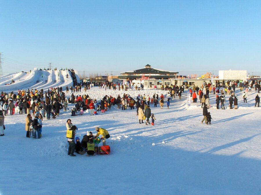 Snow play hill and inflatable slides at the Satoland family site of Sapporo Snow Festival