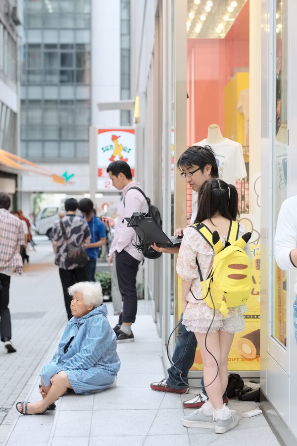 Crowd of Pokemon GO players gathered around a downtown Tokyo street during the 2016 launch