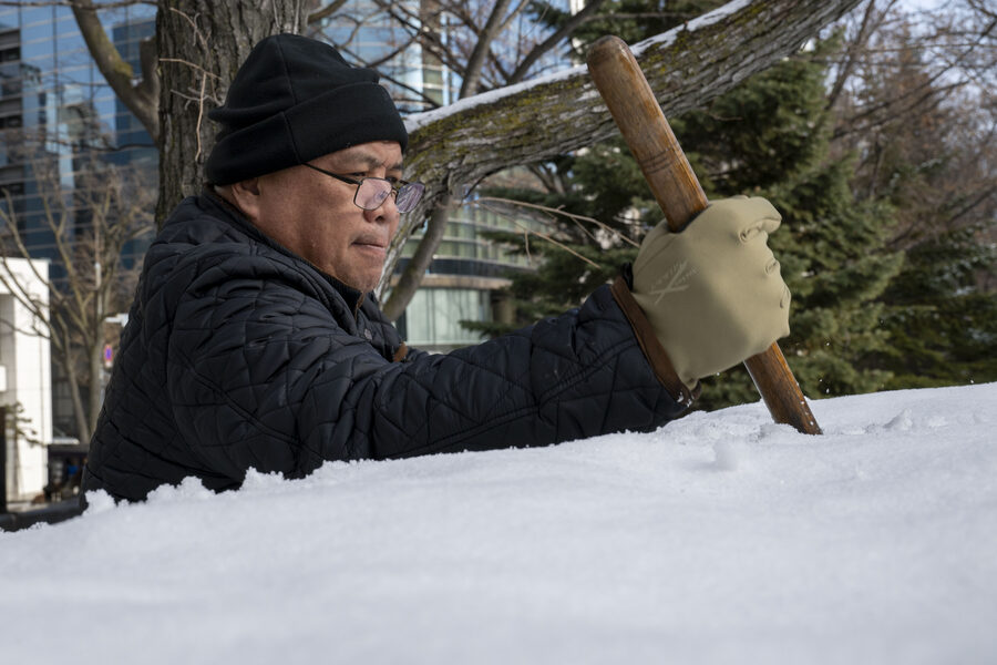 Aviation ordnanceman shaping a snow sculpture at the 75th Sapporo Snow Festival