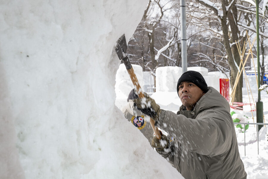 Aviation support equipment technician working on snow sculpture at Sapporo 2025