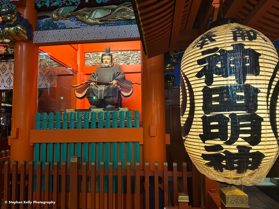 An interior shrine altar at Kanda Myojin with brass lanterns hanging on either side.