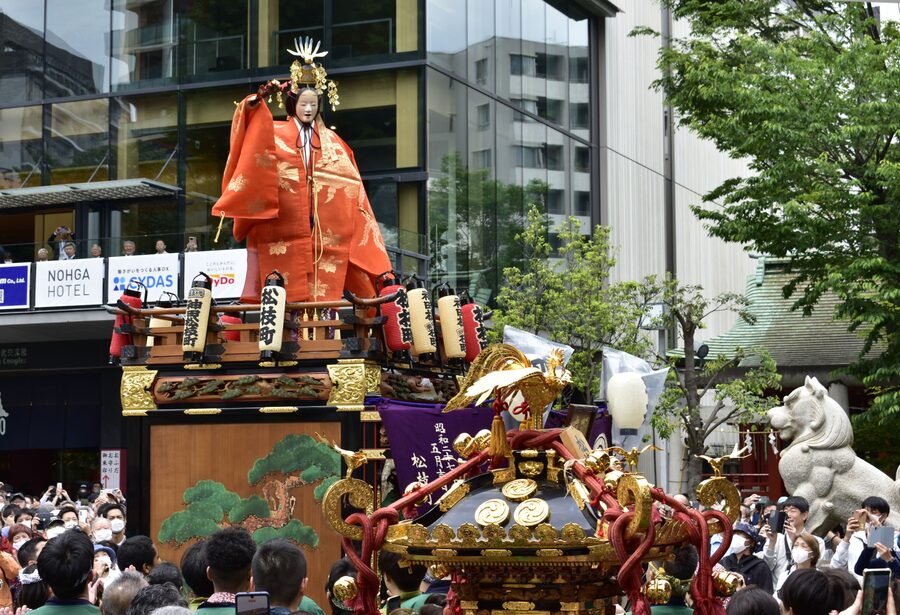 Detailed view of an elaborately decorated parade float at Kanda Matsuri 2023, showing gold and red lacquerwork on a hoko-gata dashi.