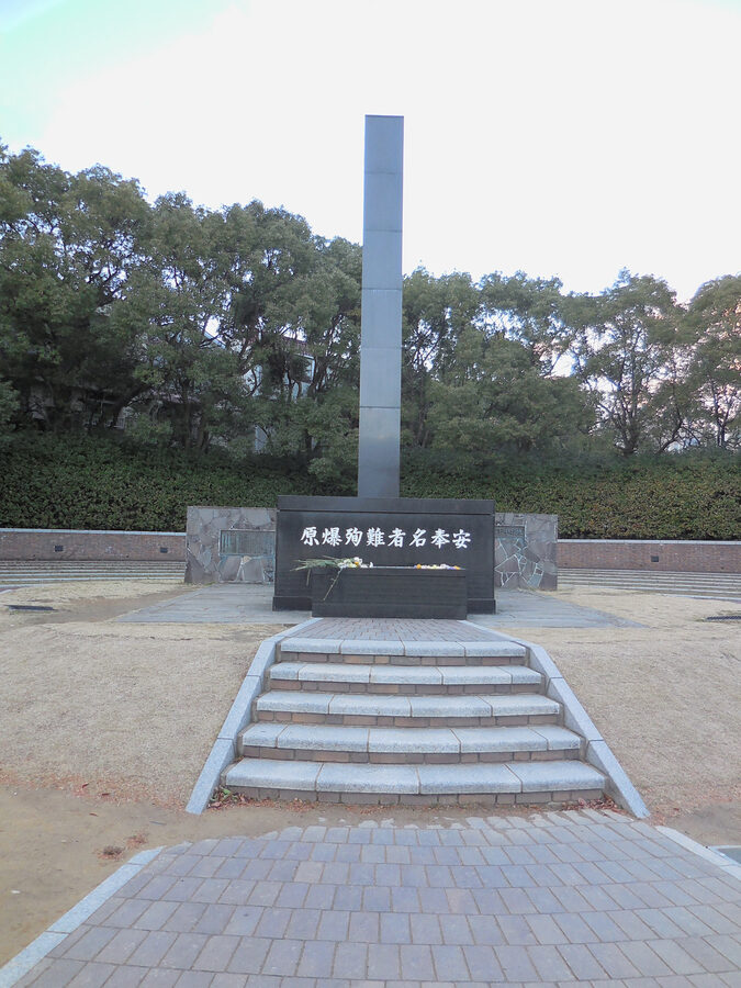 Black stone monolith marking the hypocenter of the Nagasaki atomic bombing in Peace Park