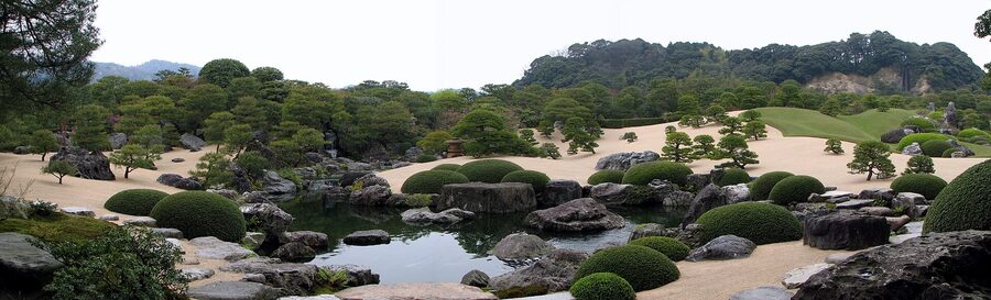 View across the central pond at Adachi Museum garden in Yasugi with shaped pines