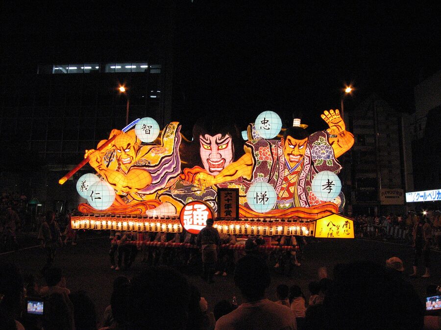 Wide-angle view of a Nebuta float swinging through Aomori on a hot August evening in 2006.