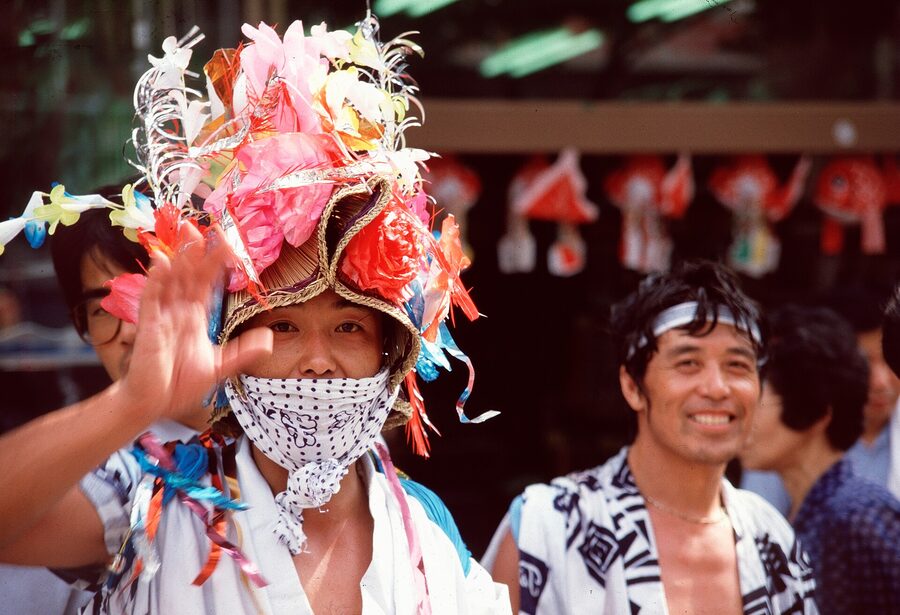 The side profile of a warrior Nebuta, jaw set, brush strokes visible on the washi paper face from a few metres away.