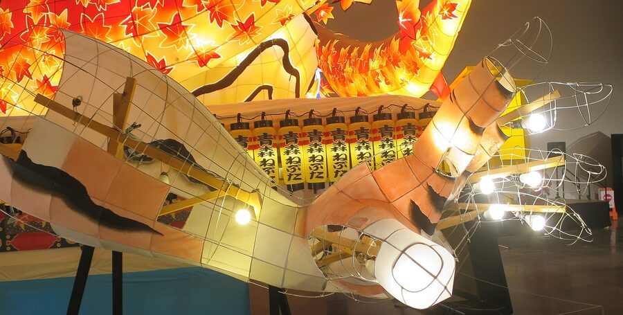 A purposely unpainted section of a Nebuta arm exposes the wire skeleton that holds the washi-paper skin.