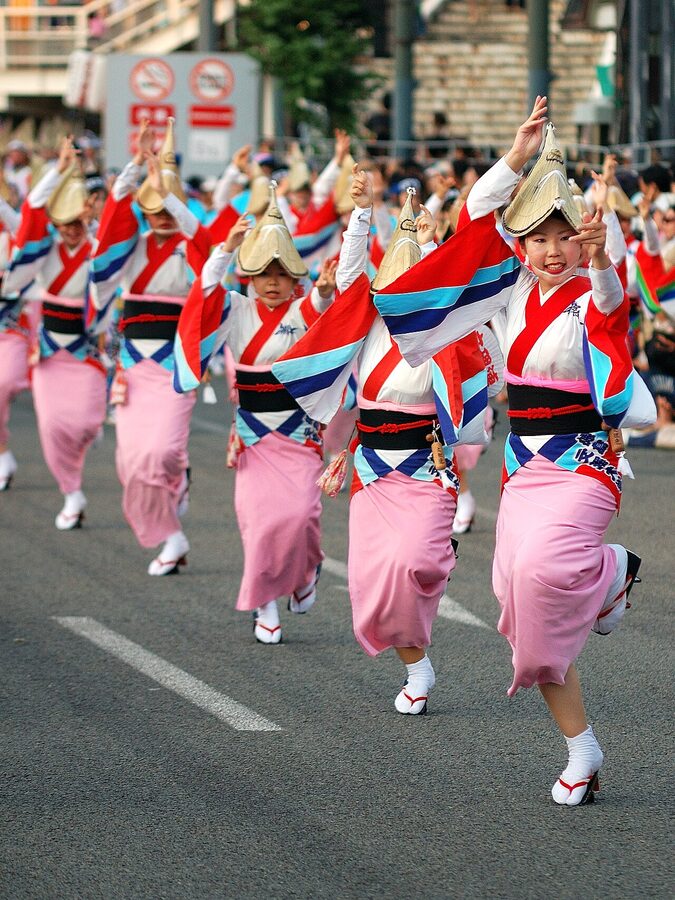 Female Awa Odori dancers in yukata and amigasa straw hats parading in Tokushima city, August 2008