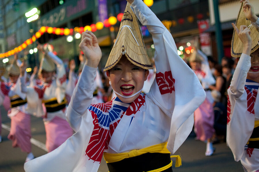 Women in amigasa hats line Awa Odori