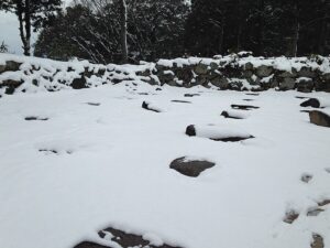The foundation stones of the tenshu at Azuchi Castle site covered in snow, Ōmihachiman Shiga, showing the square platform where Nobunagas seven-storey keep stood for six years until 1582