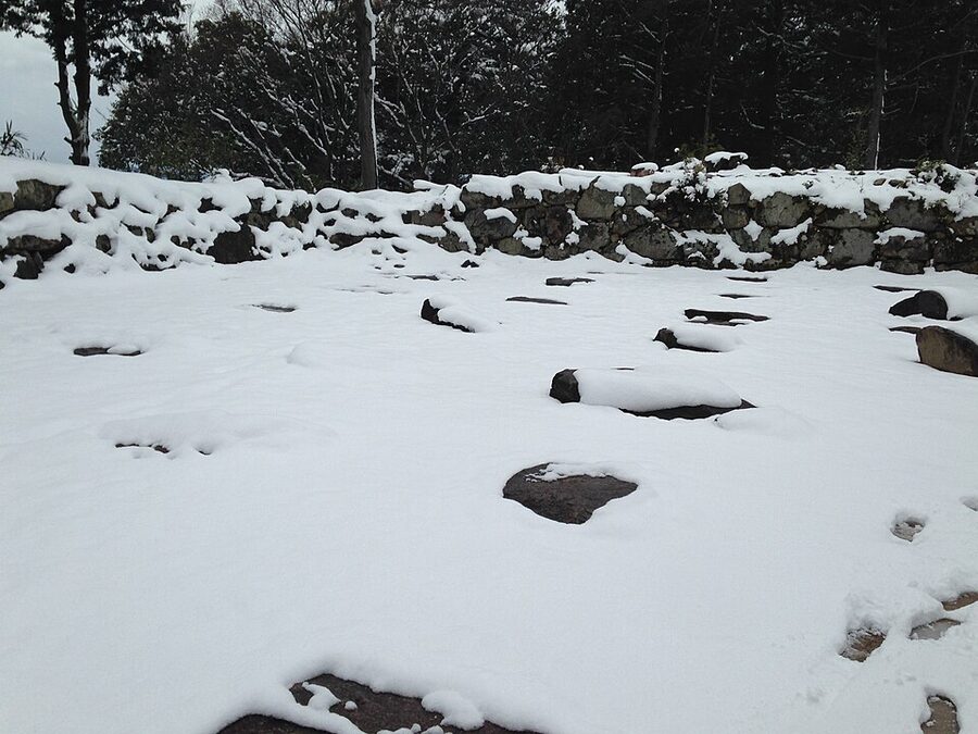 The foundation stones of the tenshu at Azuchi Castle site covered in snow, Ōmihachiman Shiga, showing the square platform where Nobunagas seven-storey keep stood for six years until 1582