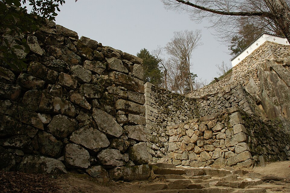 Bitchu Matsuyama Castle stone walls ishigaki winding along the Mount Gagyu ridge showing the connection between the honmaru and the outer Ni-no-maru enclosure