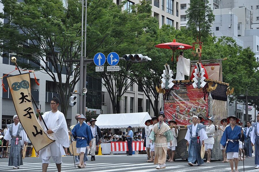Young boy chigo in ceremonial costume atop the Naginata-hoko float during Gion Matsuri