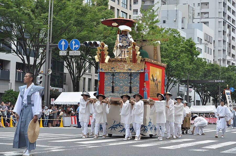 Yamaboko float crew pulling on the long tow rope during Gion Matsuri procession
