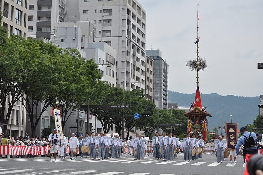 Heirloom tapestries hanging from the sides of a yamaboko float during Gion Matsuri parade in Kyoto