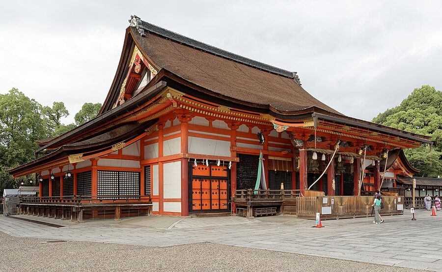 Honden main hall of Yasaka Jinja shrine in vermillion lacquer with characteristic Gion-zukuri roof
