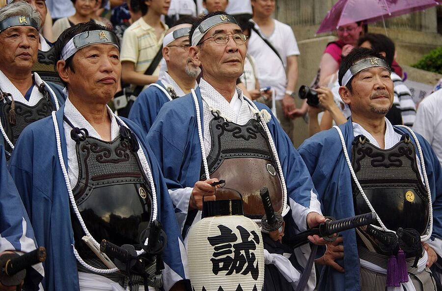 Yoiyama crowd walking past a yamaboko float in central Kyoto during Gion Matsuri evening