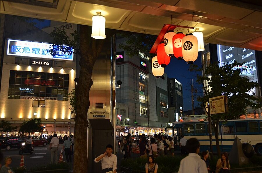 Paper lanterns and crowds filling a central Kyoto street during Gion Matsuri Yoiyama evening