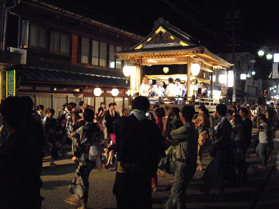 The yagura tower at Gujo Odori with dancers in yukata circling around it in Gujo Hachiman, Gifu