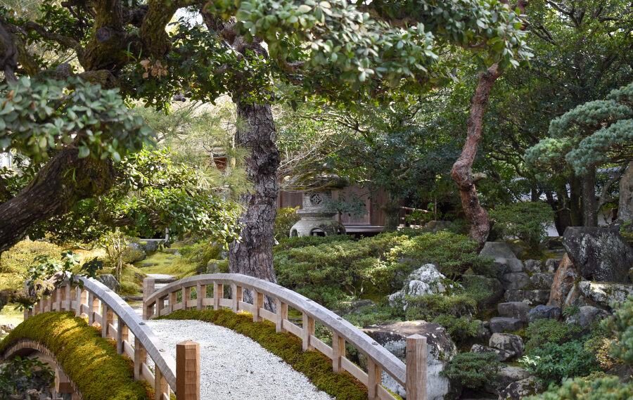 Garden of Kyoto Imperial Palace with traditional pond and stone bridge