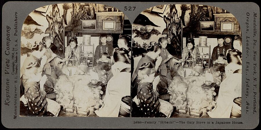 Keystone View Company c.1910 stereograph of a Japanese family gathered around their hibachi as the household primary heating and cooking source