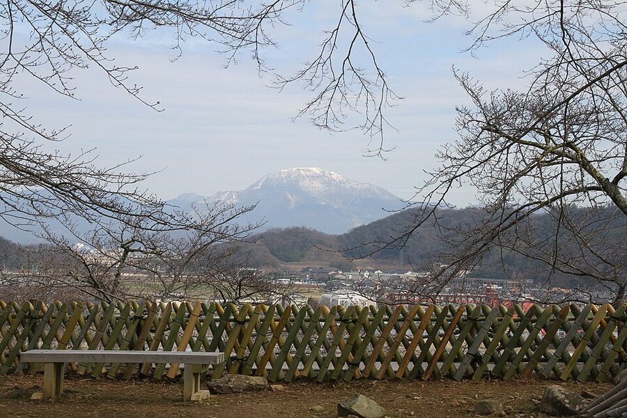 Hikone Castle tenshu in winter snow with white plaster walls and snow covered roof ridges traditional angle for winter visit photography