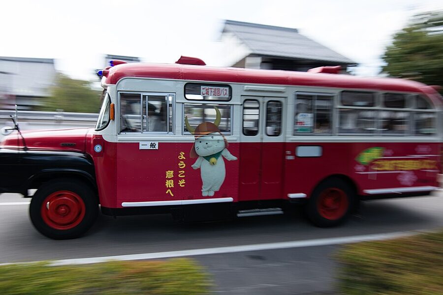 Hikonyan mascot performing at Hikone Castle with white cat costume and red Ii Naomasa helmet