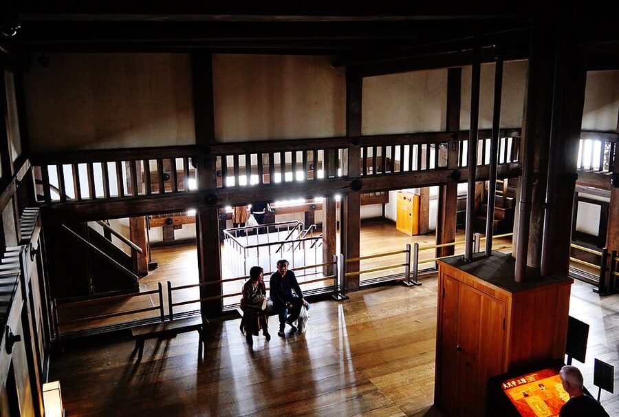 Interior of Himeji Castle main keep showing the massive wooden pillars and traditional post-and-beam construction