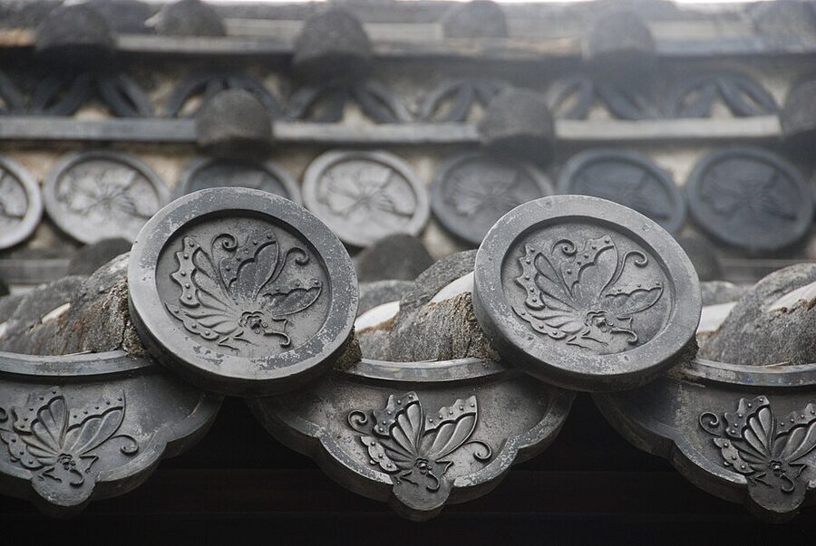 Roof tiles at Himeji Castle showing family crests of the successive lords including the Ikeda butterfly and Honda hollyhock