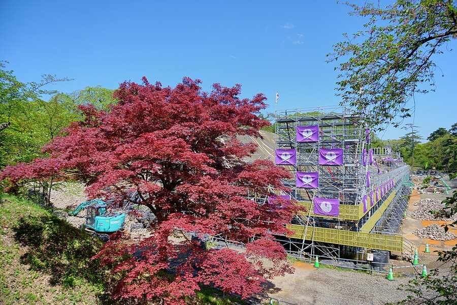 Close view of disassembled stone wall at Hirosaki Castle honmaru during the 2015 to 2024 great stone-wall repair project with numbered blocks staged for reassembly