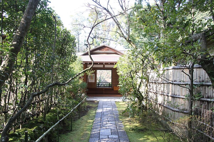 The approach garden at Kotoin sub-temple of Daitokuji Kyoto with a stone-paved path flanked by autumn maples