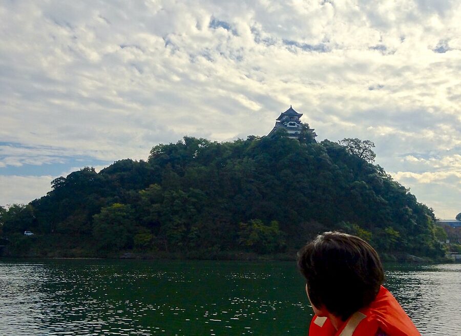 Inuyama Castle from a pleasure boat on the Kiso River showing the cliff base and the keep above