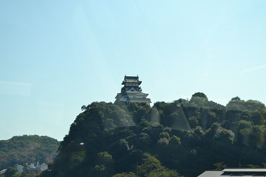 Inuyama Castle keep on its cliff above the Kiso River viewed from the north bank