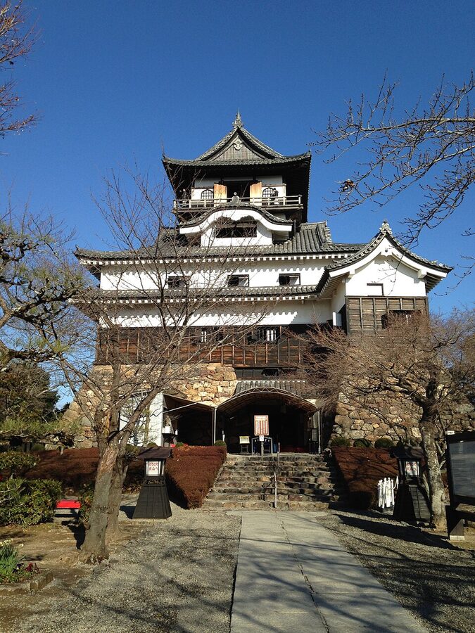 Inuyama Castle tenshu in January snow showing the white walls against the black winter sky