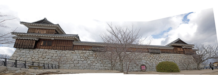 Panoramic view of Iyo-Matsuyama Castle on Mt Katsuyama showing the renketsu-shiki linked keep complex with main tenshu small tenshu and corner turrets