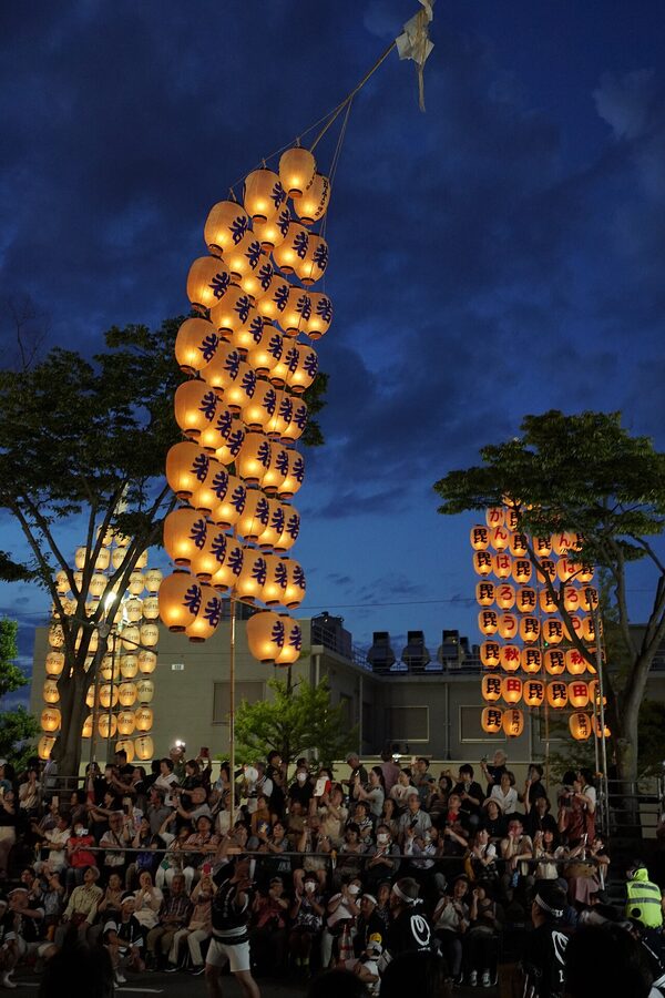 Performer balancing 12-meter kanto pole with 46 lanterns Akita 2023