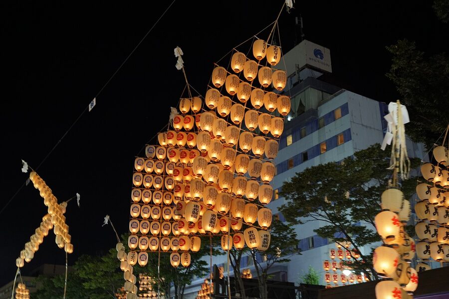 Performer balancing kanto pole on shoulder kata position Akita 2023