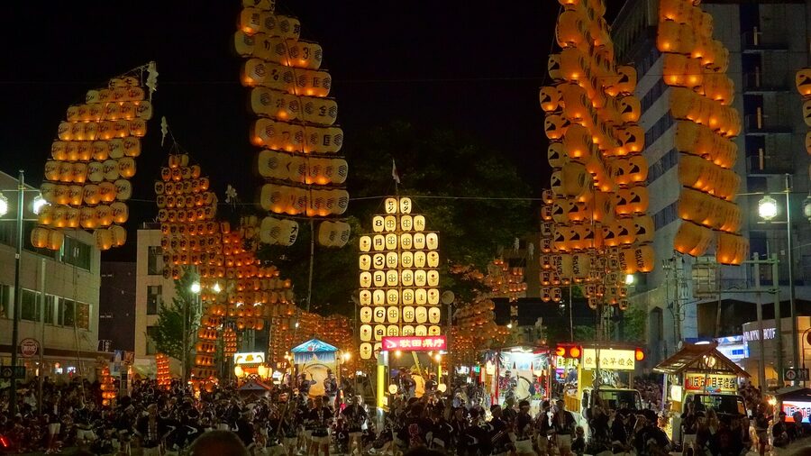 Long row of illuminated kanto poles down Kanto Odori Akita 2019