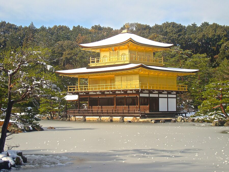Kinkaku-ji the Golden Pavilion above a frozen Kyoko-chi pond during winter snowfall in Kyoto on New Years Day 2011