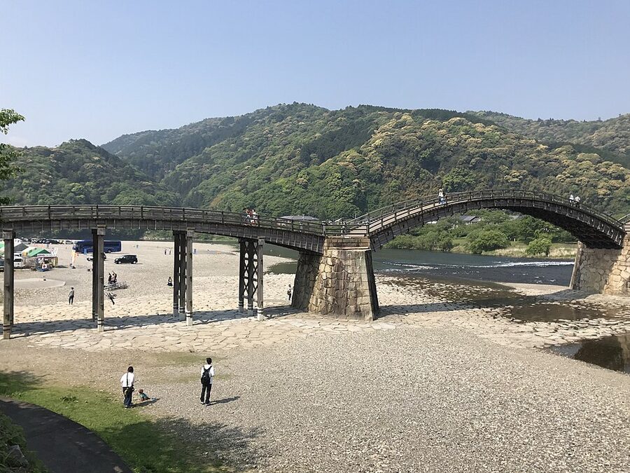 The Kintai-kyo five-arched wooden bridge spanning the Nishiki River at Iwakuni, Yamaguchi Prefecture, daytime view with reflection