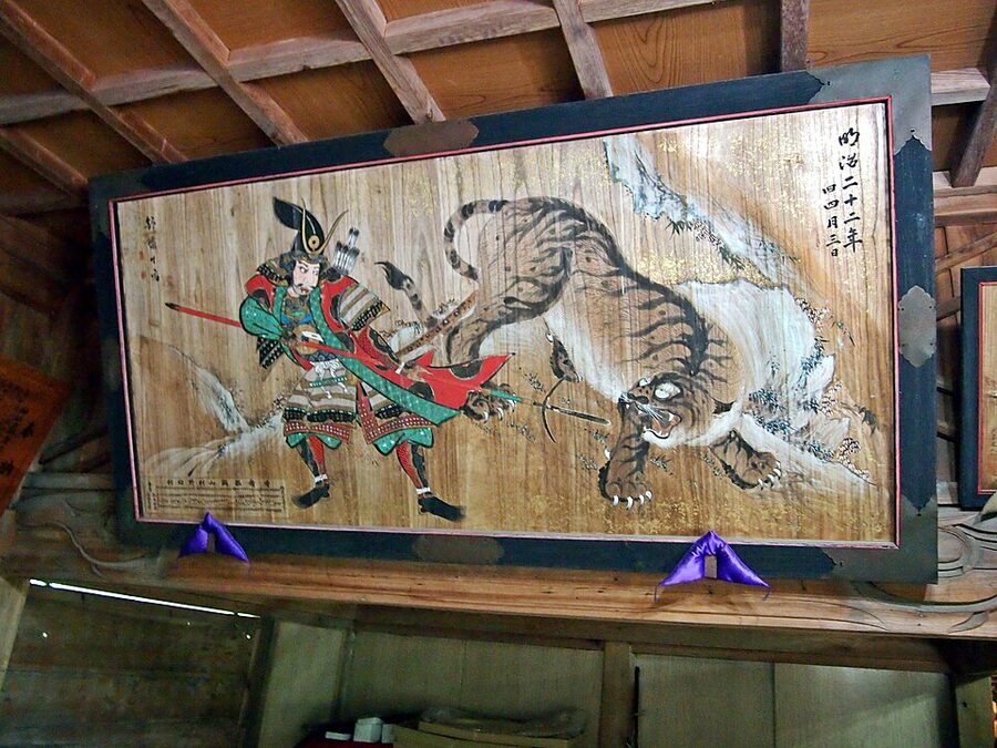Yoshitoshi woodblock of a samurai spearing a leaping tiger in Korea reproduced as one of the canonical images of Kiyomasas tiger hunts