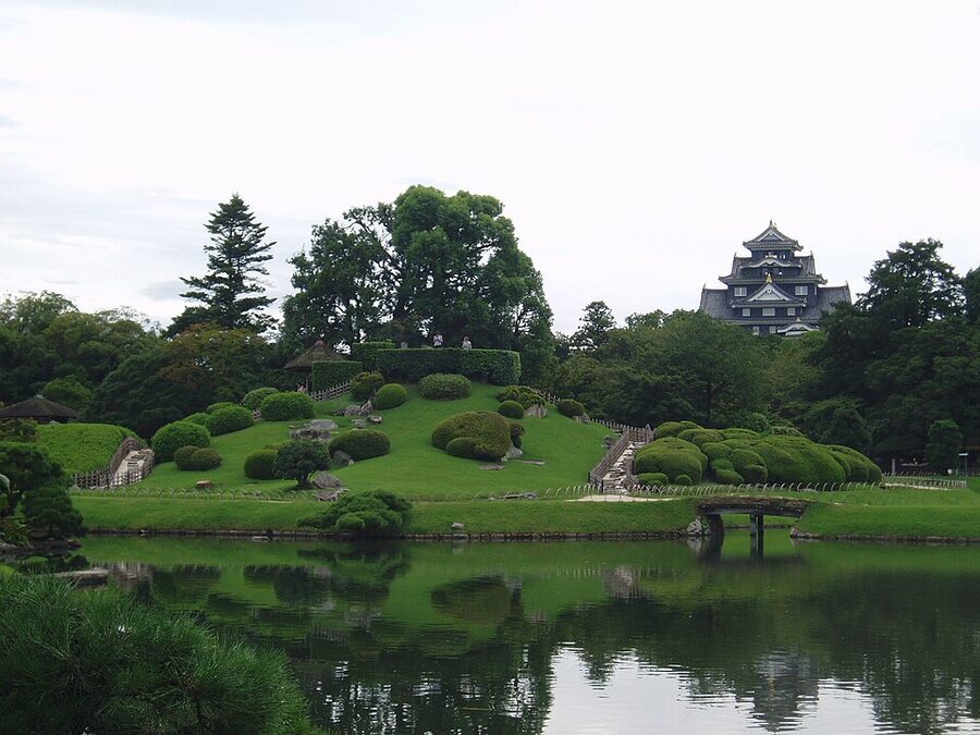 View across Korakuen pond with the black-walled Okayama Castle keep in the distance used as borrowed scenery