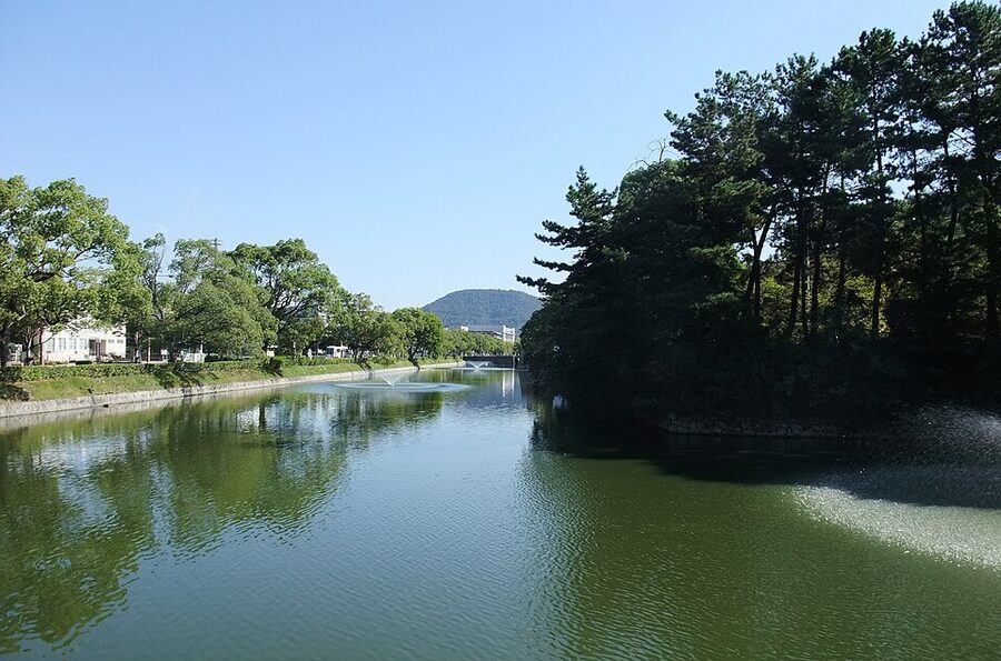 The outer moat and stone bank of Marugame Castle in autumn