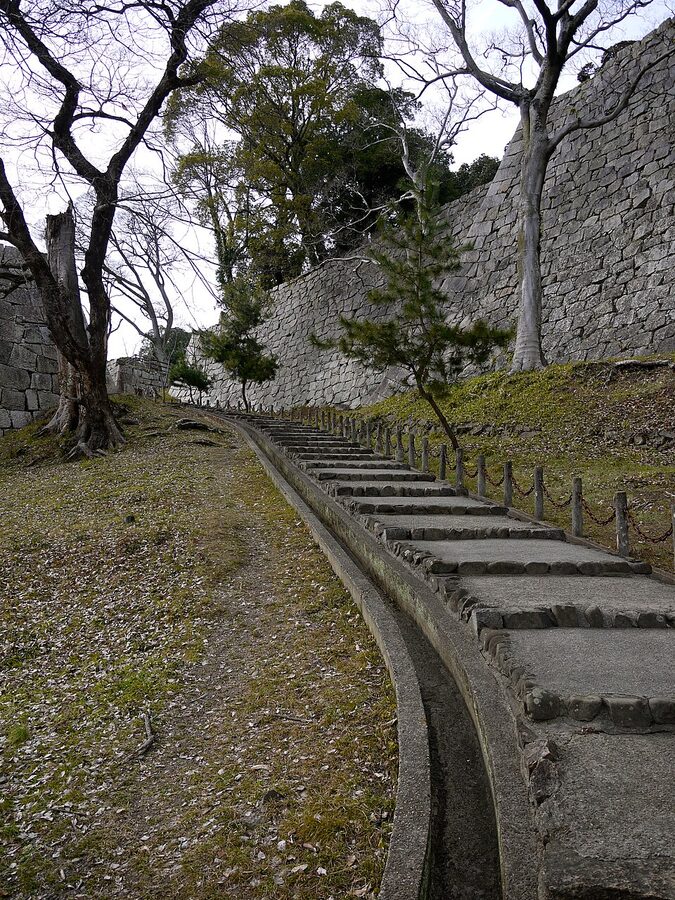 Stone stairs climbing between layered ishigaki at Marugame Castle