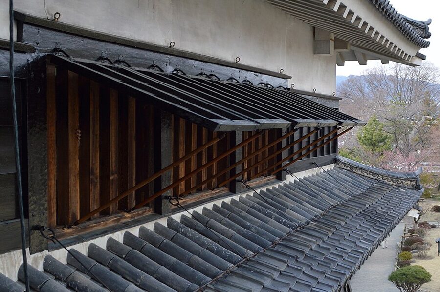 Close detail view of the black lacquered window shutters of the Matsumoto Castle daitenshu seen from the inside of the Tatsumi-tsukeyagura connecting turret